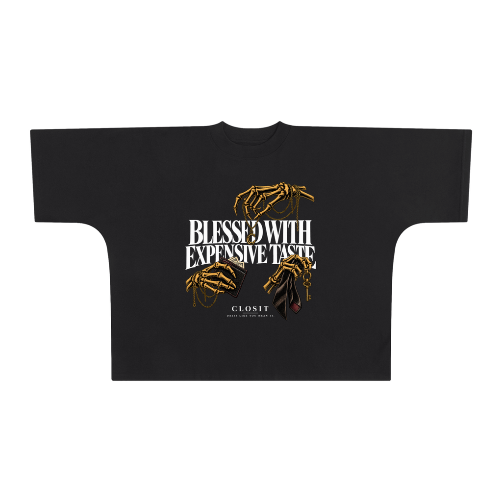 Black oversized boxy T-shirt, front view with Blessed with Expensive Taste slogan and gold skeletal hands holding accessories.