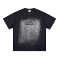 Black washed T-shirt, front view with small chest slogan against a faded square.